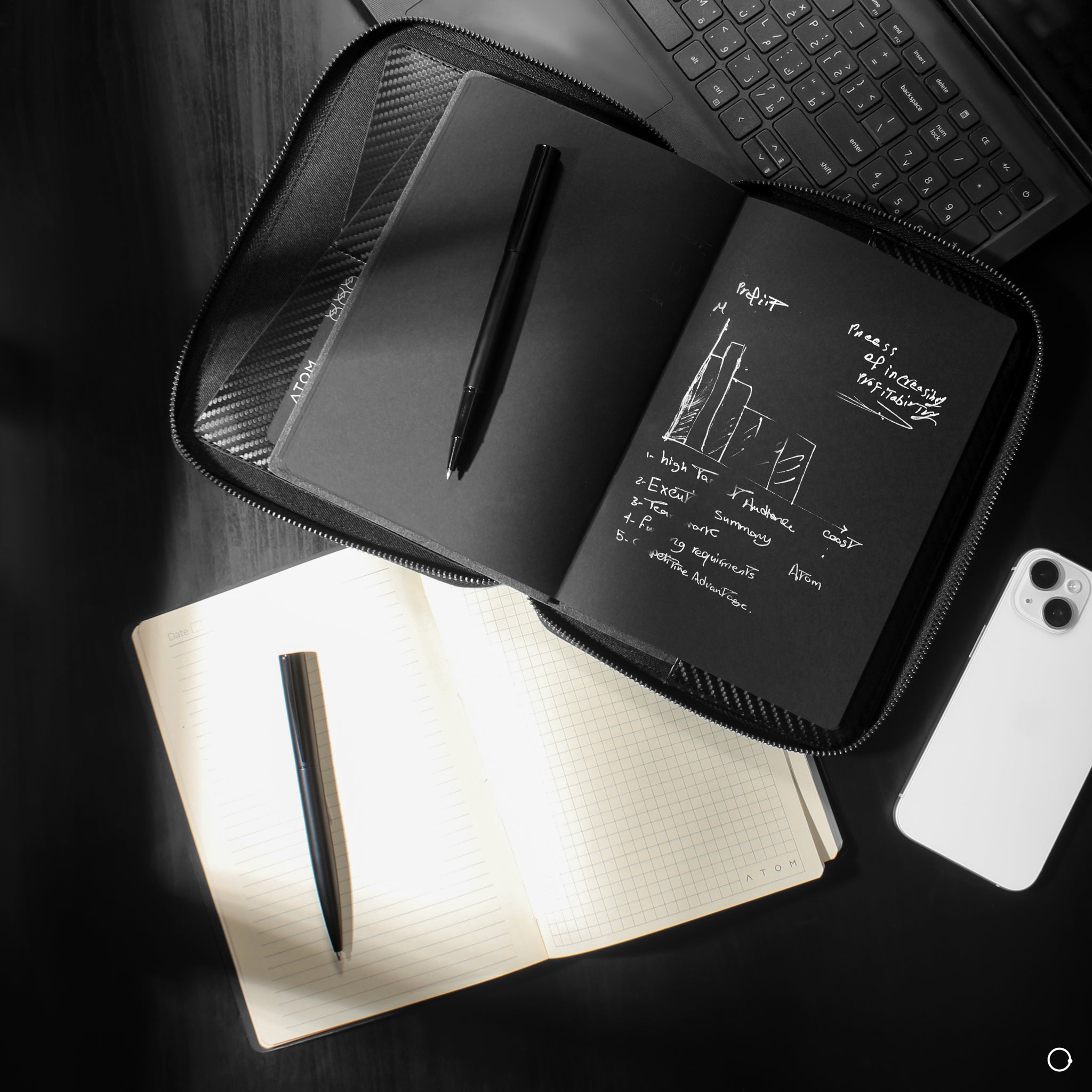 black notebook with silver pen