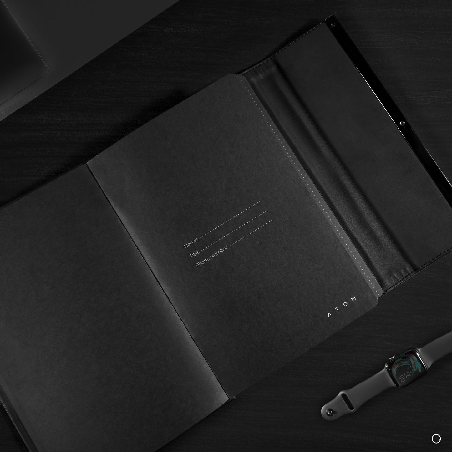 Black notebook and silver pen