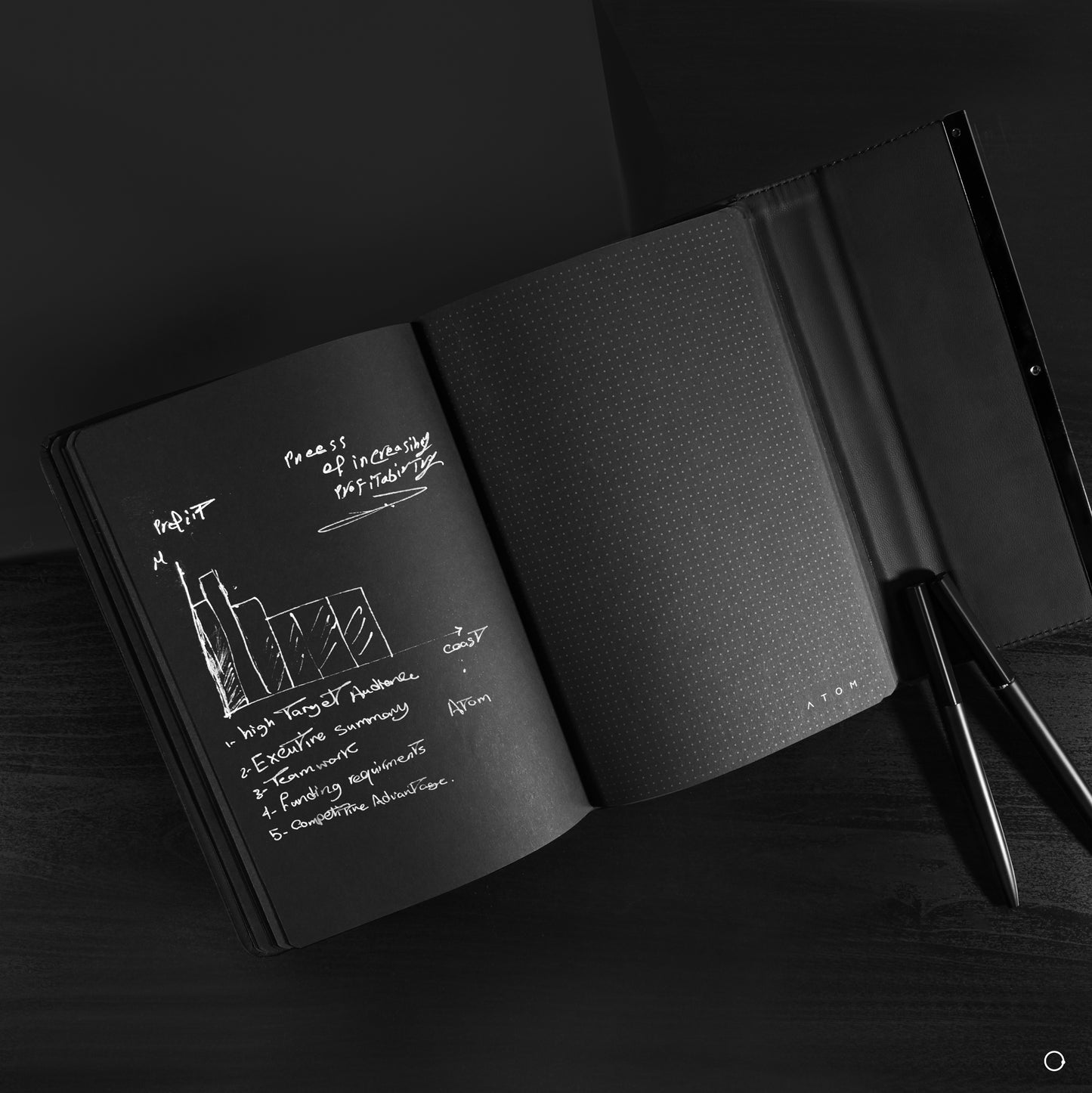 Black notebook and silver pen