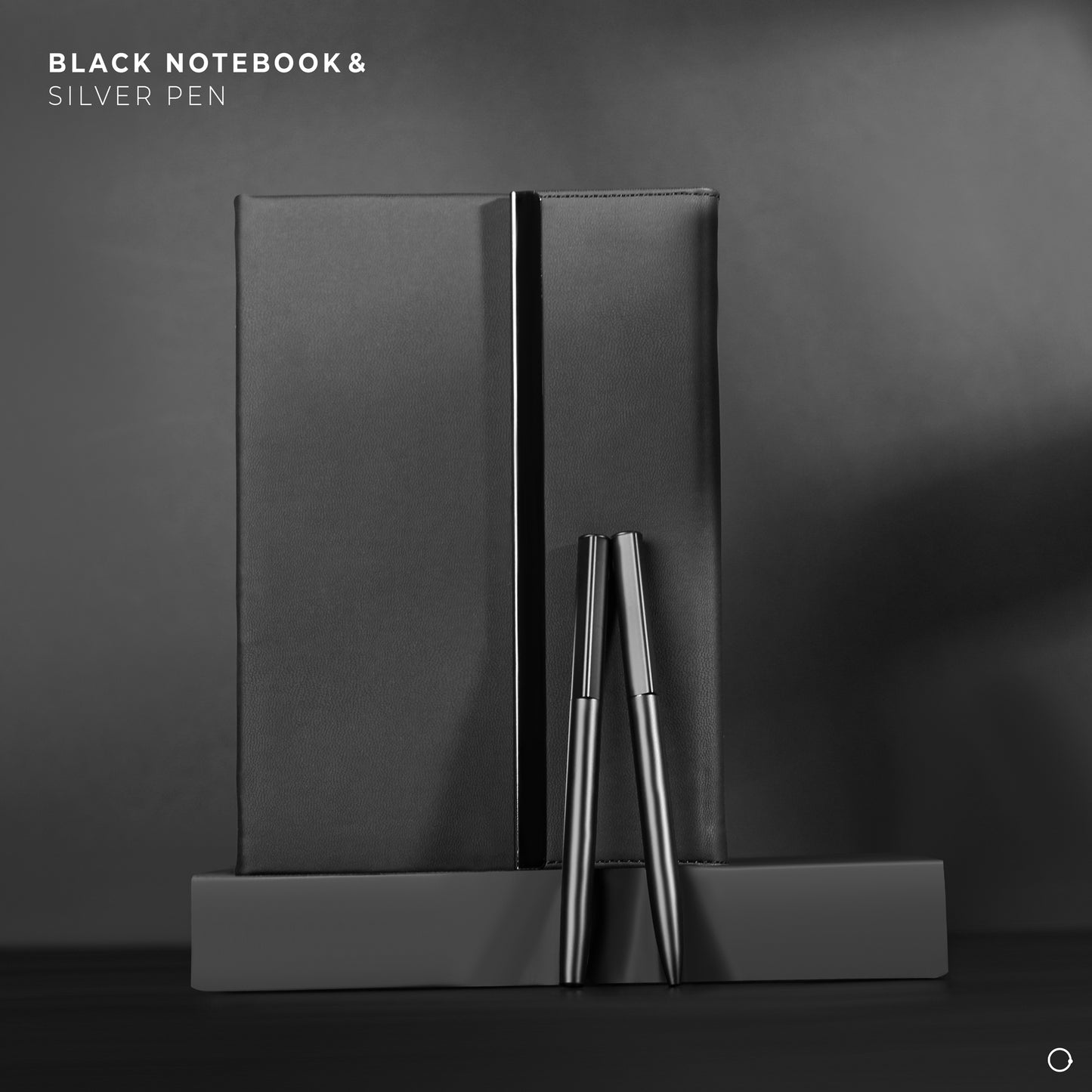 Black notebook and silver pen