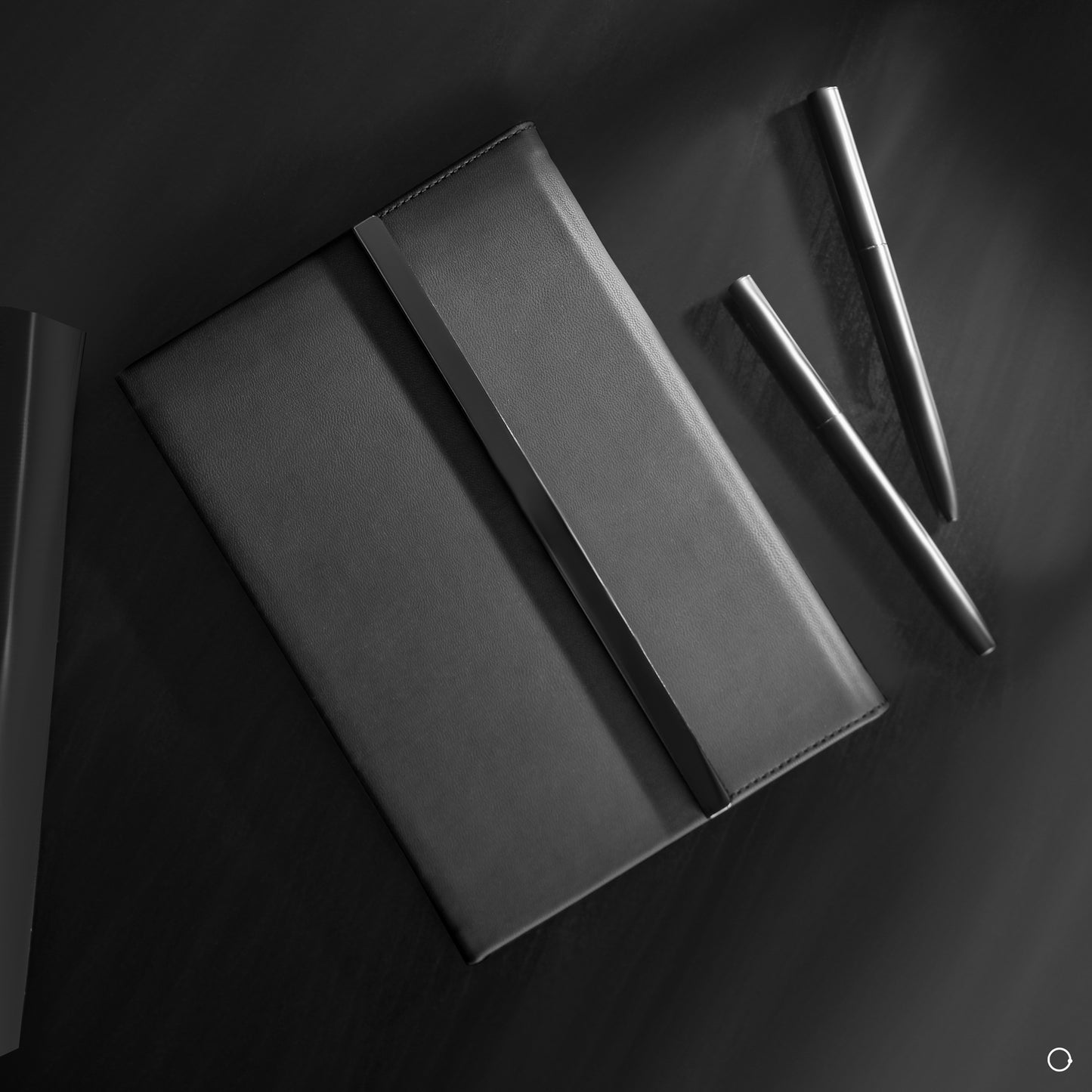 Black notebook and silver pen