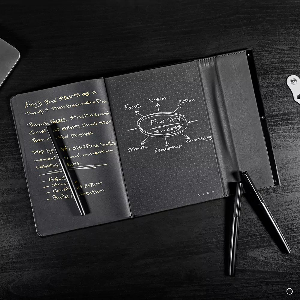 Black notebook and silver pen