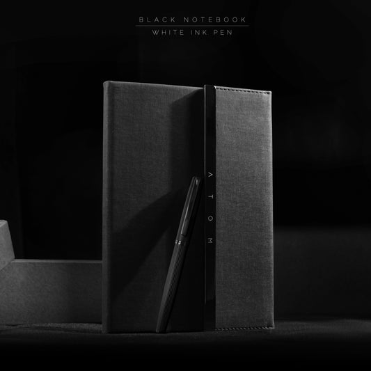 Black notebook and silver pen