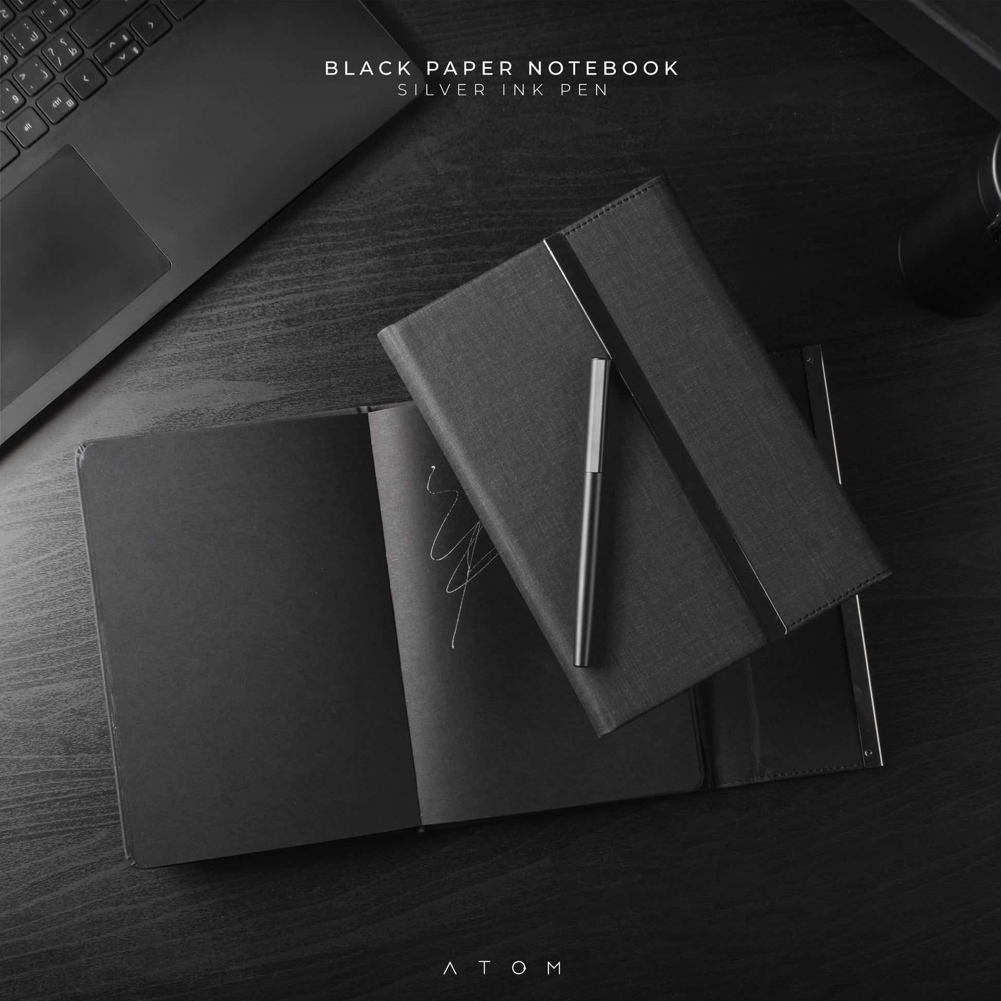 black note book and silver pen