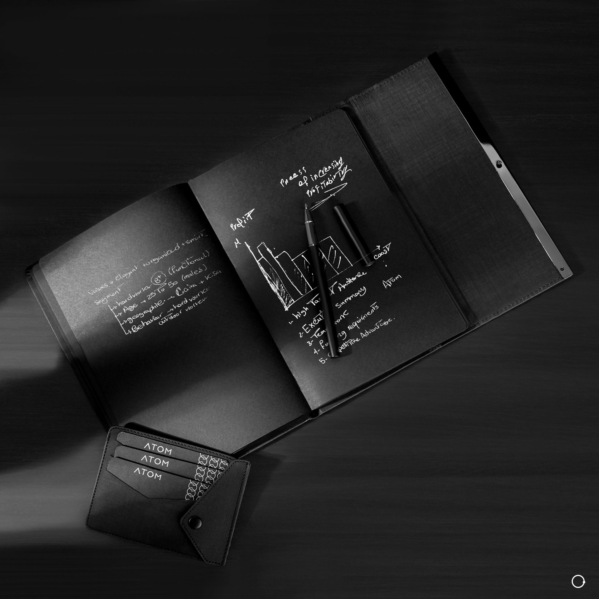 black notebook and silver pen 