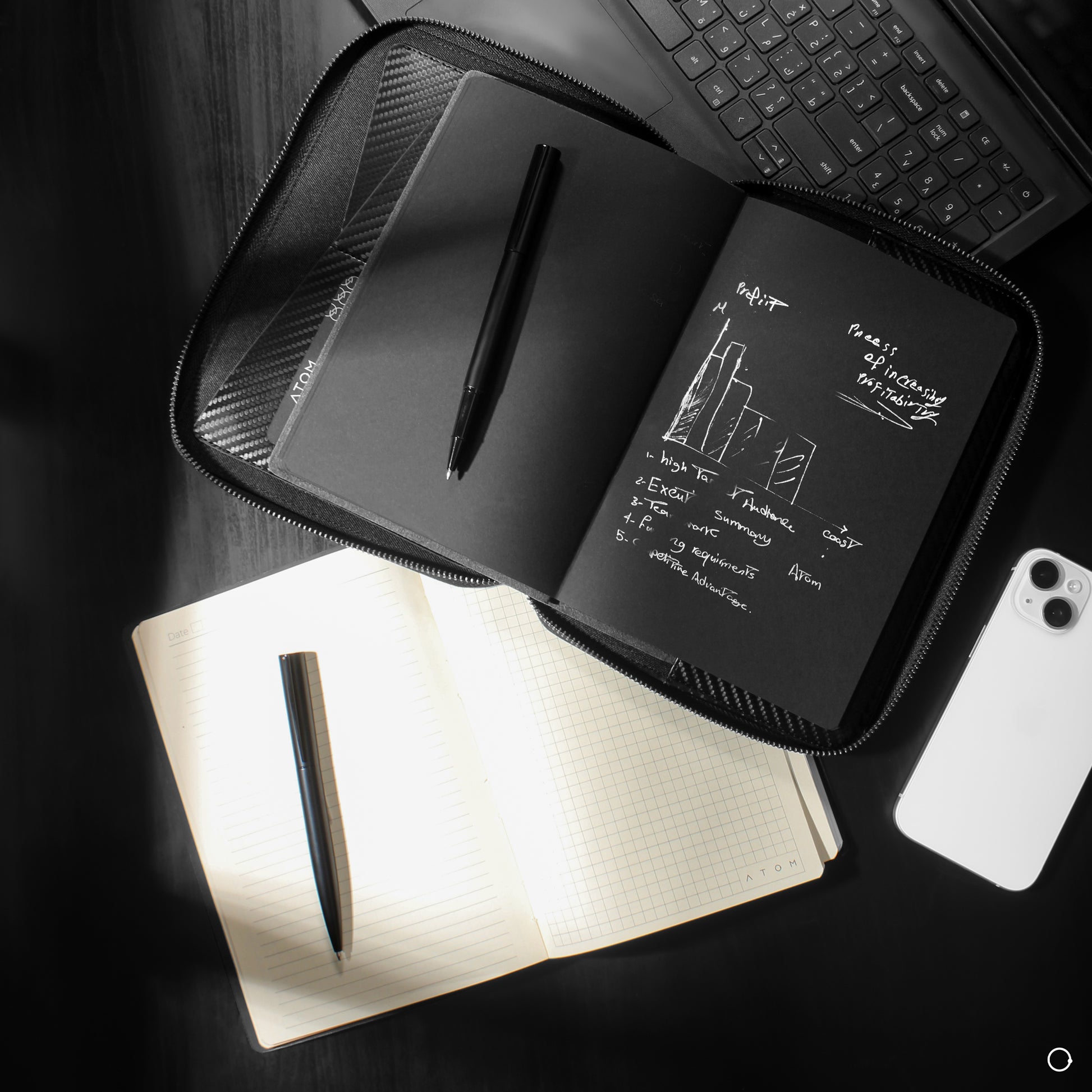black notebook with silver pen 